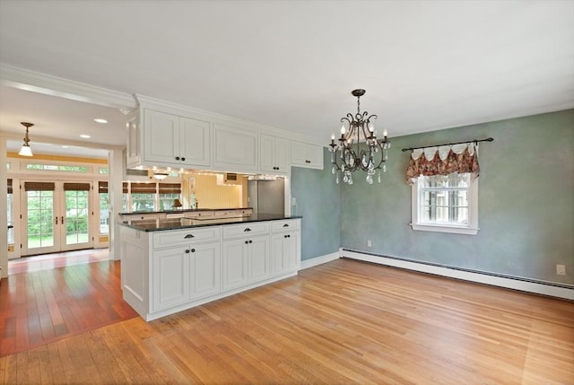 14 Prince St, Danvers, MA 01923 - kitchen with light wood-style flooring, dark countertops, french doors, and white cabinets