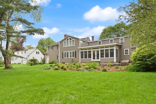 14 Prince St, Danvers, MA 01923 - rear view of house featuring a chimney, a sunroom, a lawn, and french doors