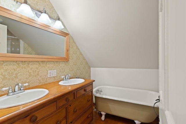 14 Prince St, Danvers, MA 01923 - bathroom featuring a freestanding tub, double vanity, lofted ceiling, and wallpapered walls