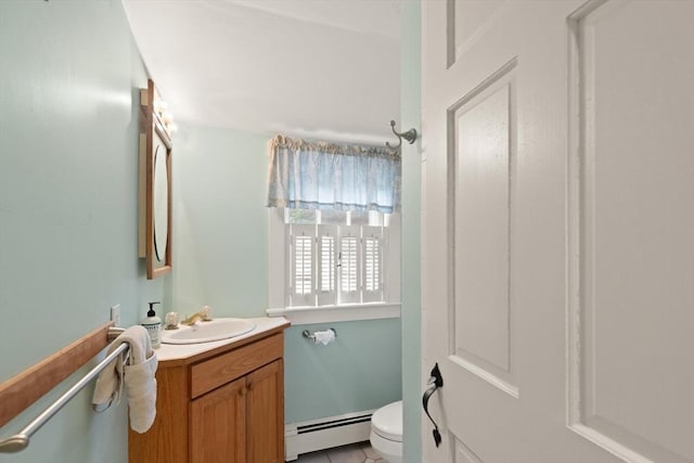 14 Prince St, Danvers, MA 01923 - half bath featuring baseboard heating, toilet, vanity, and tile patterned flooring