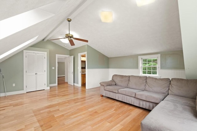 14 Prince St, Danvers, MA 01923 - living room featuring light wood-style flooring, a skylight, a ceiling fan, and a wainscoted wall