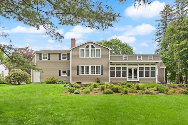 14 Prince St, Danvers, MA 01923 - rear view of property featuring a chimney, a yard, and a sunroom