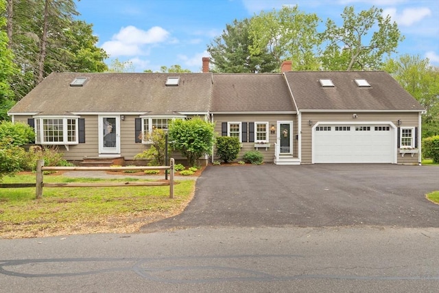 14 Prince St, Danvers, MA 01923 - view of front of home with an attached garage, driveway, and a chimney