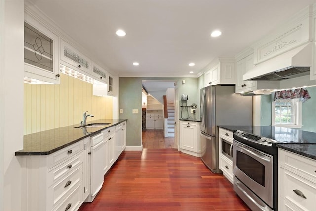 14 Prince St, Danvers, MA 01923 - kitchen featuring stainless steel appliances, a sink, dark wood-style flooring, crown molding, and glass insert cabinets