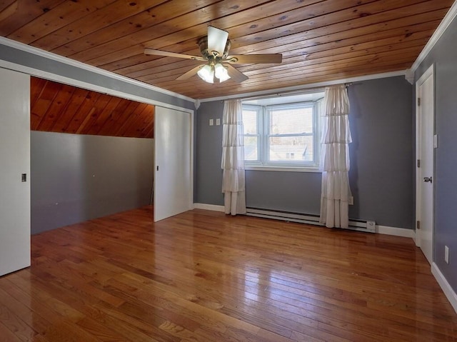 interior space featuring ornamental molding, wood-type flooring, and wooden ceiling