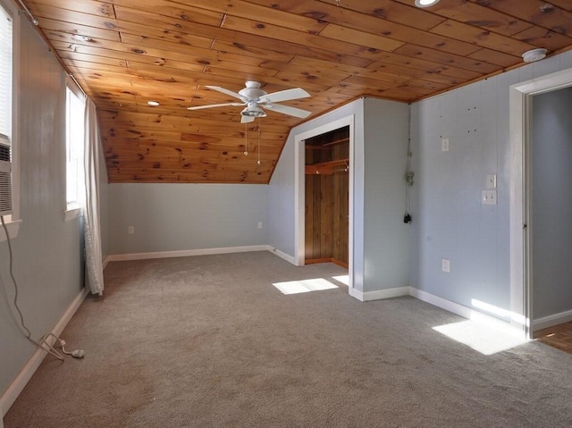 additional living space with wood ceiling, vaulted ceiling, light colored carpet, and ceiling fan