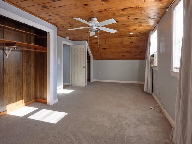 unfurnished bedroom featuring vaulted ceiling, light colored carpet, wooden ceiling, and a closet