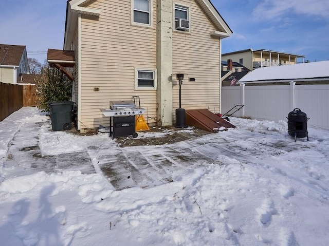 snow covered property with cooling unit