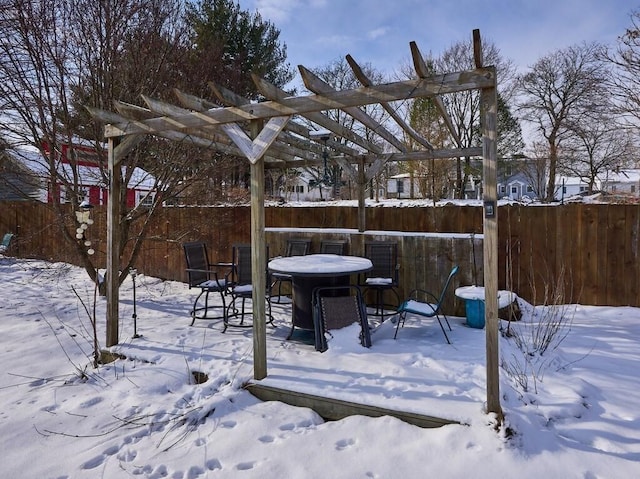 yard covered in snow with a pergola