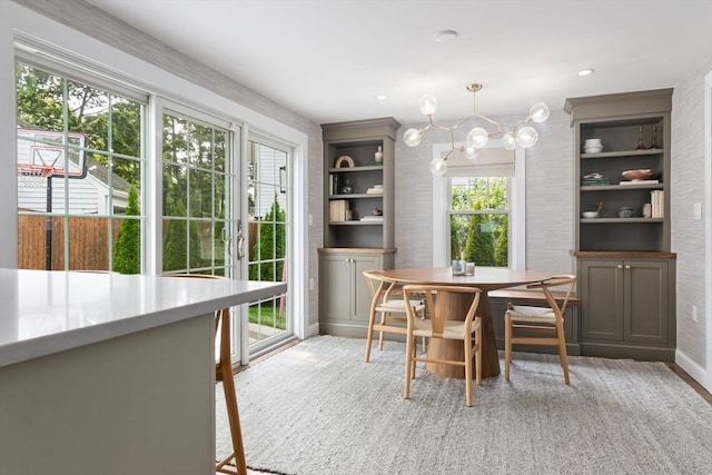 71 Sheffield Rd, Melrose, MA 02176 - dining area with a chandelier, baseboards, and light wood finished floors