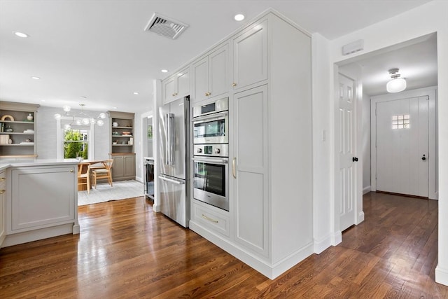 71 Sheffield Rd, Melrose, MA 02176 - kitchen featuring stainless steel appliances, dark wood finished floors, recessed lighting, white cabinets, and light countertops