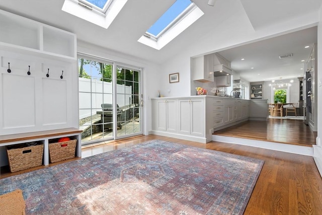 71 Sheffield Rd, Melrose, MA 02176 - mudroom with plenty of natural light, a skylight, wood finished floors, vaulted ceiling, and recessed lighting