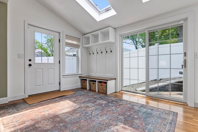 71 Sheffield Rd, Melrose, MA 02176 - mudroom featuring healthy amount of natural light, a skylight, lofted ceiling, wood finished floors, and baseboards