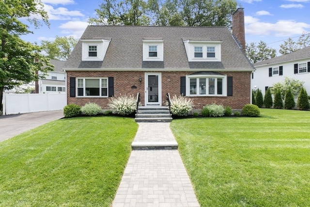 71 Sheffield Rd, Melrose, MA 02176 - view of front of house featuring brick siding, a chimney, and roof with shingles