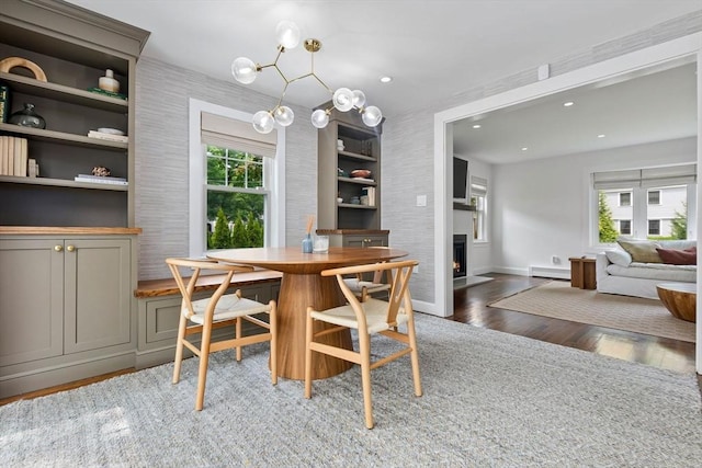 71 Sheffield Rd, Melrose, MA 02176 - dining area featuring wood finished floors, a fireplace with flush hearth, baseboards, recessed lighting, and a baseboard radiator