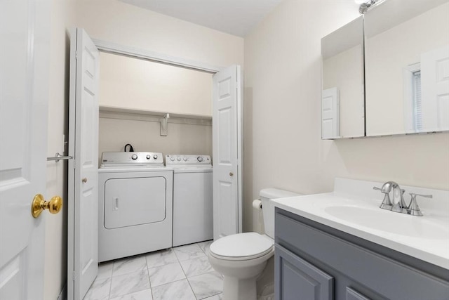 bathroom with separate washer and dryer, toilet, marble finish floor, and vanity