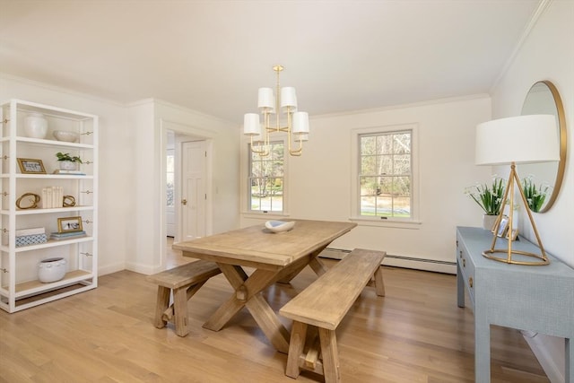dining room with an inviting chandelier, ornamental molding, baseboards, baseboard heating, and light wood-type flooring