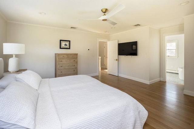 bedroom featuring crown molding, visible vents, wood finished floors, baseboards, and ceiling fan