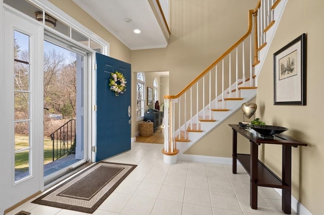 tiled entryway featuring stairway, recessed lighting, baseboards, and ornamental molding