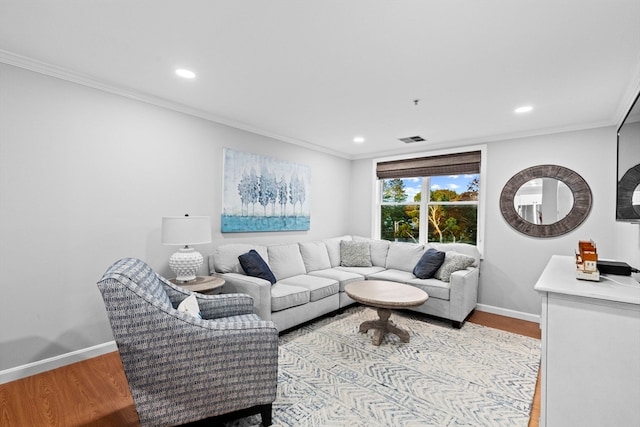 living room with ornamental molding and light wood-type flooring