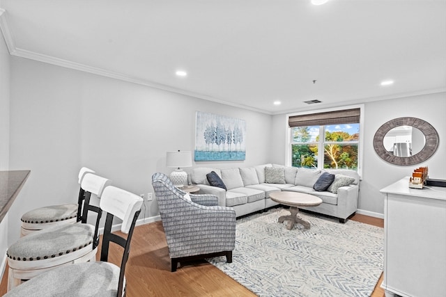 living room featuring light hardwood / wood-style floors and ornamental molding