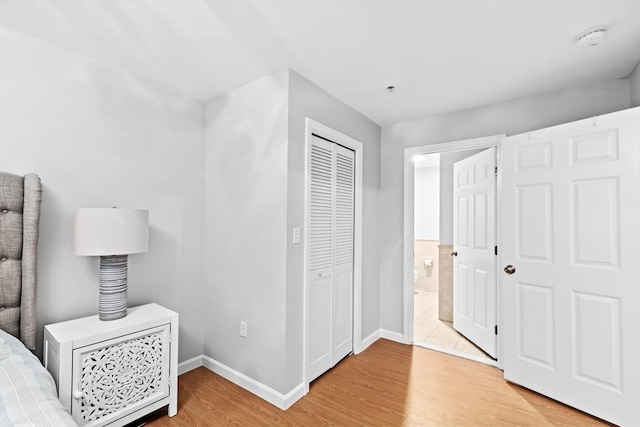 bedroom with a closet and hardwood / wood-style flooring