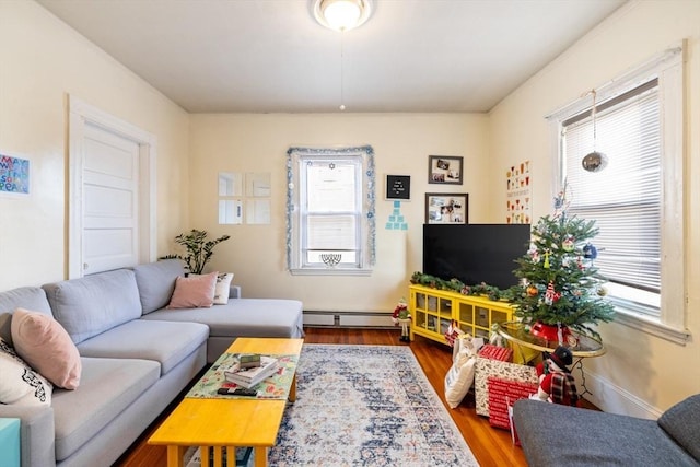 living room with baseboard heating and hardwood / wood-style flooring