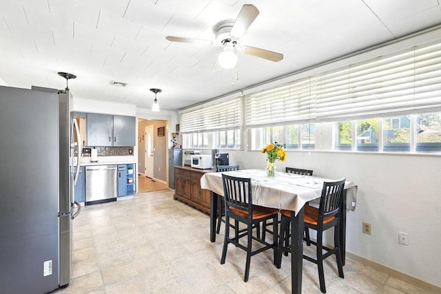 dining space with baseboards, plenty of natural light, a ceiling fan, and visible vents