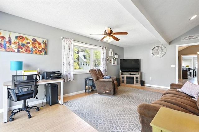living room featuring baseboards, ceiling fan, and wood finished floors