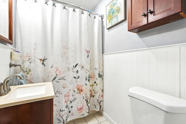full bathroom with vanity, a wainscoted wall, tile patterned floors, toilet, and a shower with shower curtain