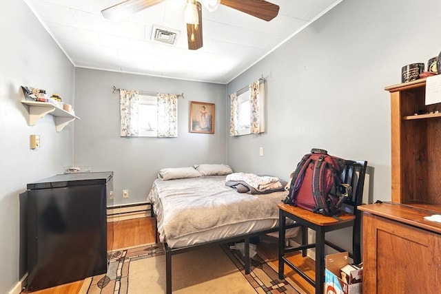 bedroom featuring visible vents, a baseboard radiator, ceiling fan, and ornamental molding
