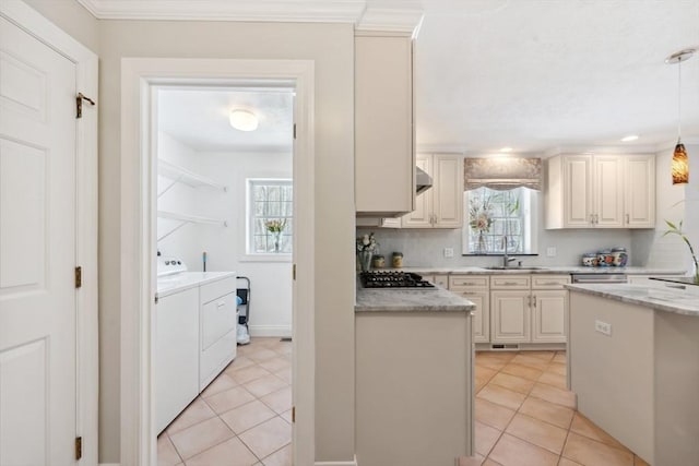 6 Hutchins Way, Westford, MA 01886 - kitchen featuring washing machine and clothes dryer, stainless steel gas cooktop, a sink, light tile patterned floors, and hanging light fixtures