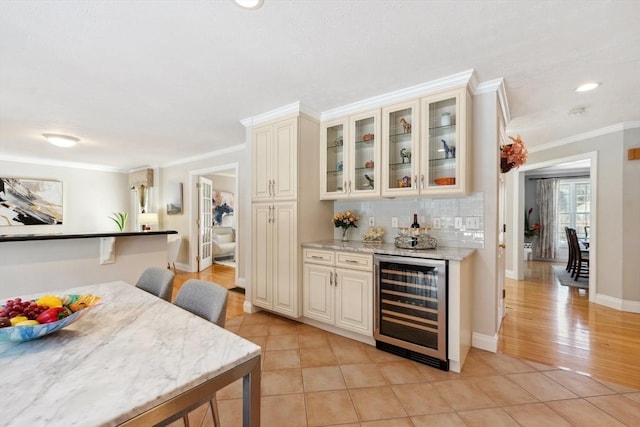 6 Hutchins Way, Westford, MA 01886 - indoor bar featuring wine cooler, crown molding, light tile patterned floors, baseboards, and decorative backsplash