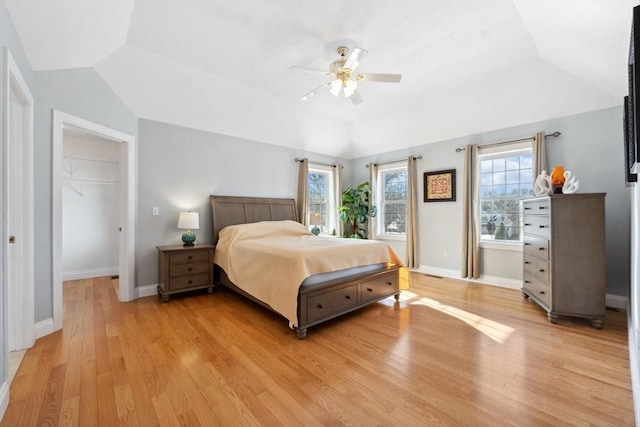 6 Hutchins Way, Westford, MA 01886 - bedroom with light wood-style floors, vaulted ceiling, baseboards, ceiling fan, and a walk in closet