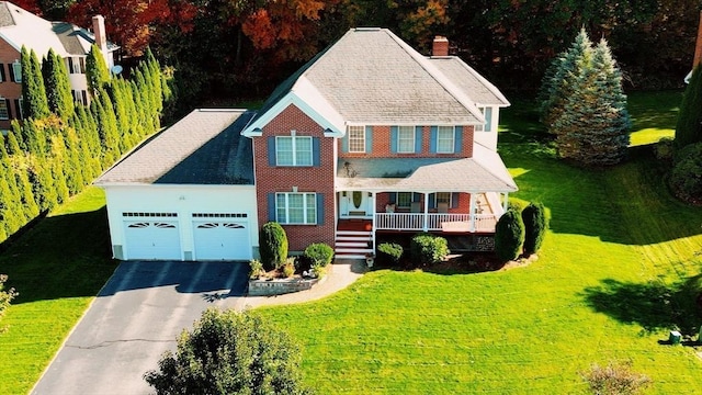 6 Hutchins Way, Westford, MA 01886 - view of front facade with covered porch, a chimney, driveway, a garage, and a front yard