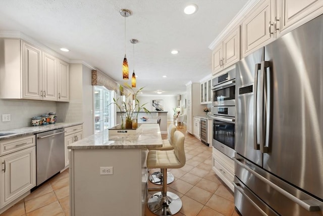 6 Hutchins Way, Westford, MA 01886 - kitchen with stainless steel appliances, a kitchen bar, recessed lighting, a center island, and pendant lighting