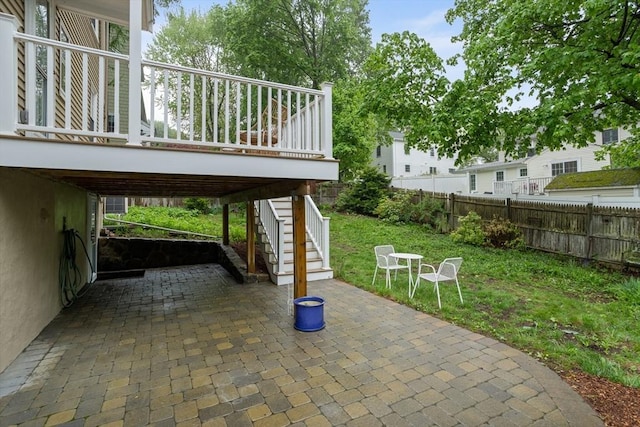 view of patio with fence and stairs