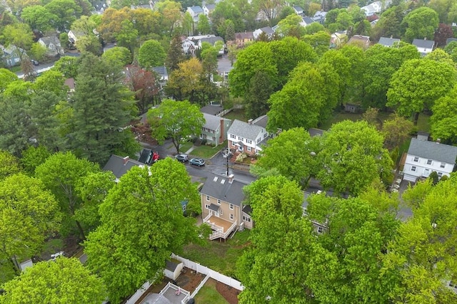 aerial view of property and surrounding area featuring nearby suburban area