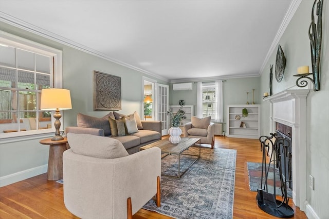 living room featuring ornamental molding, wood finished floors, radiator heating unit, a fireplace with flush hearth, and baseboards