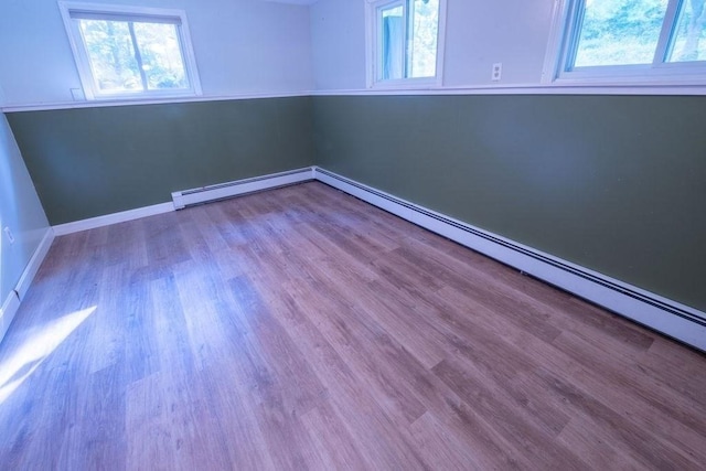 8 Adams Rd, Hubbardston, MA 01452 - spare room with plenty of natural light, wood finished floors, and baseboard heating