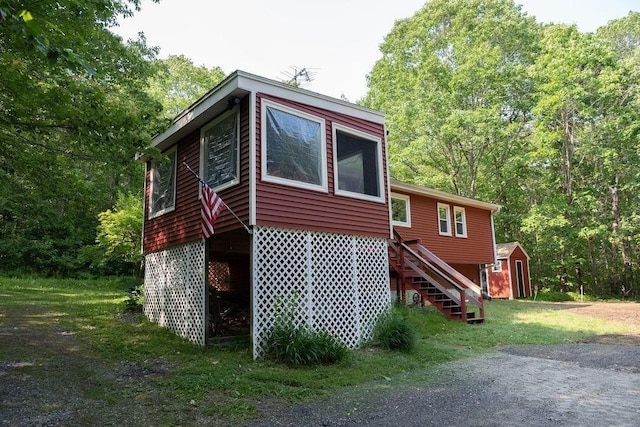 8 Adams Rd, Hubbardston, MA 01452 - view of side of property featuring stairs, a storage unit, and a forest view