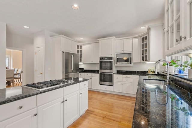 14 Sandpiper Hl, Sharon, MA 02067 - kitchen featuring appliances with stainless steel finishes, white cabinetry, light wood-style flooring, dark stone counters, and recessed lighting