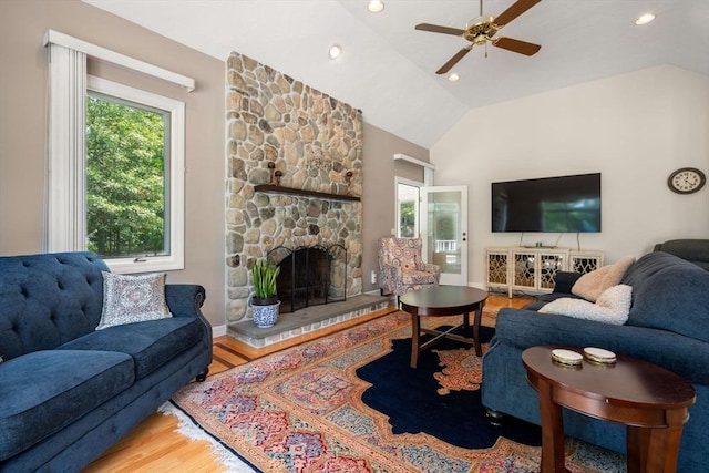 14 Sandpiper Hl, Sharon, MA 02067 - living area with plenty of natural light, a ceiling fan, wood finished floors, a stone fireplace, and vaulted ceiling