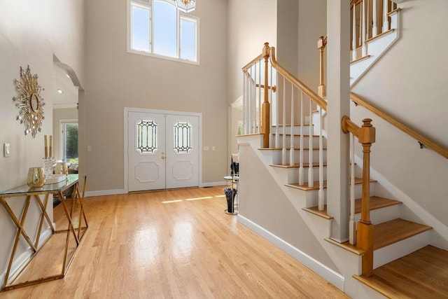 14 Sandpiper Hl, Sharon, MA 02067 - entryway featuring stairway, wood finished floors, a towering ceiling, a chandelier, and arched walkways