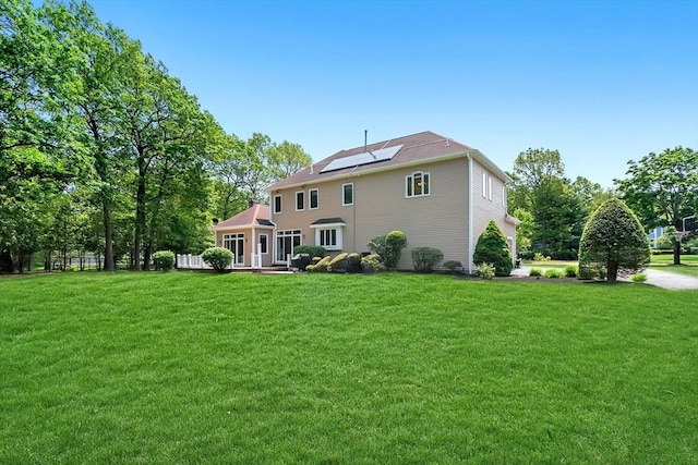14 Sandpiper Hl, Sharon, MA 02067 - rear view of house featuring roof mounted solar panels and a yard