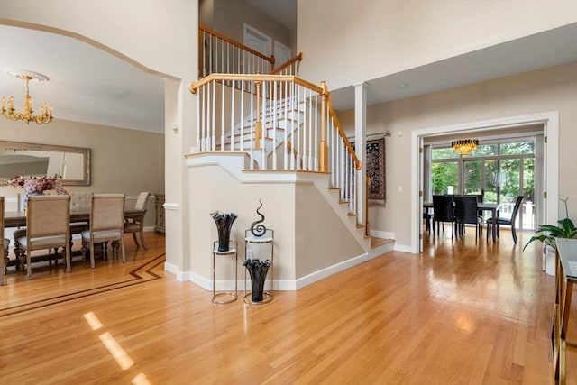 14 Sandpiper Hl, Sharon, MA 02067 - staircase featuring a chandelier, wood finished floors, and crown molding