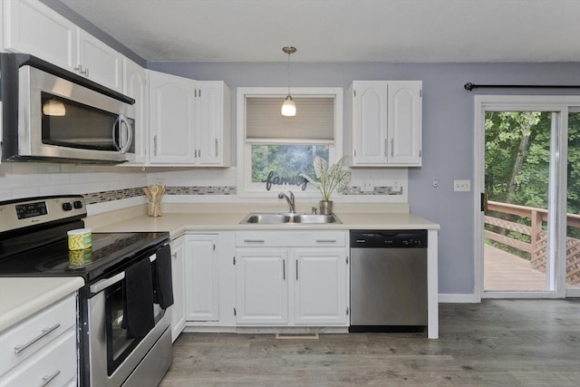 52 Marmon Ct, Springfield, MA 01129 - kitchen featuring appliances with stainless steel finishes, a sink, plenty of natural light, and white cabinetry