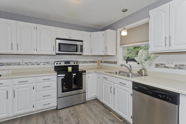 52 Marmon Ct, Springfield, MA 01129 - kitchen featuring appliances with stainless steel finishes, a sink, and white cabinets