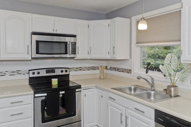 52 Marmon Ct, Springfield, MA 01129 - kitchen featuring stainless steel appliances, a sink, white cabinetry, backsplash, and light countertops