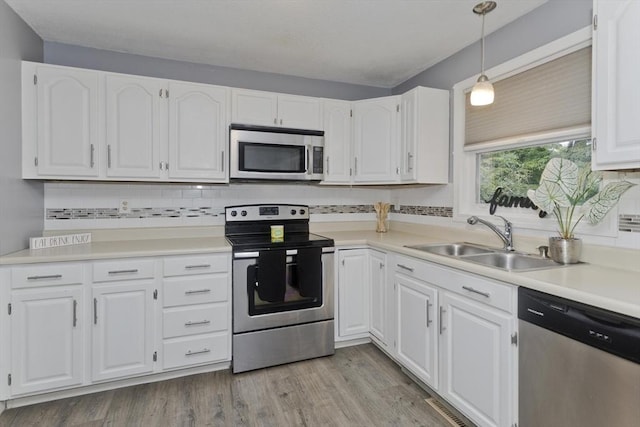 52 Marmon Ct, Springfield, MA 01129 - kitchen featuring stainless steel appliances, a sink, white cabinets, and decorative backsplash